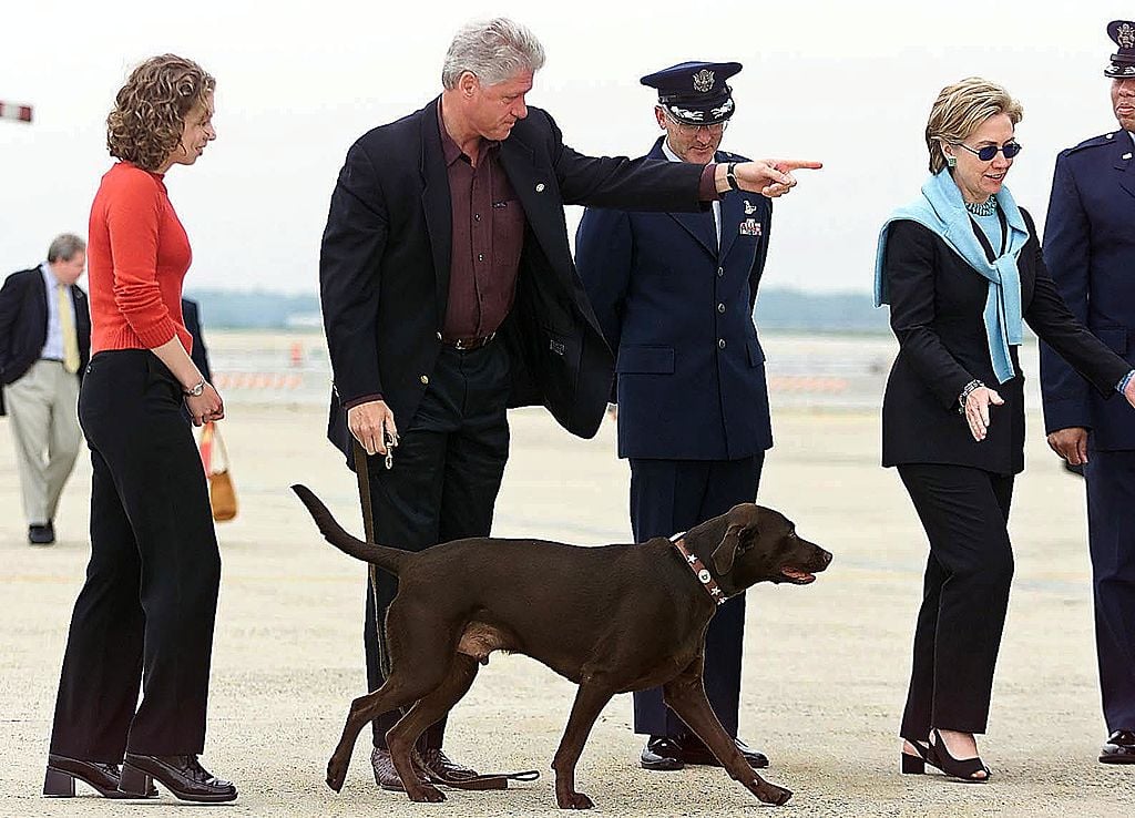 US President Bill Clinton (2nd-L) orders first dog