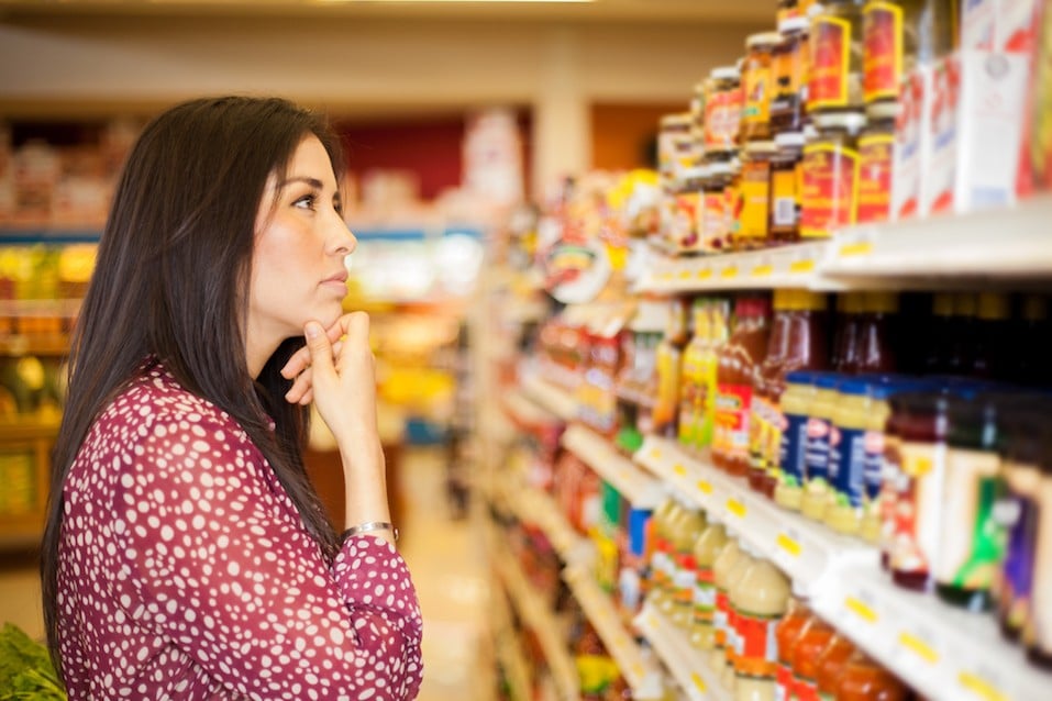 Beautiful brunette looking at some shelves trying to decide what to buy