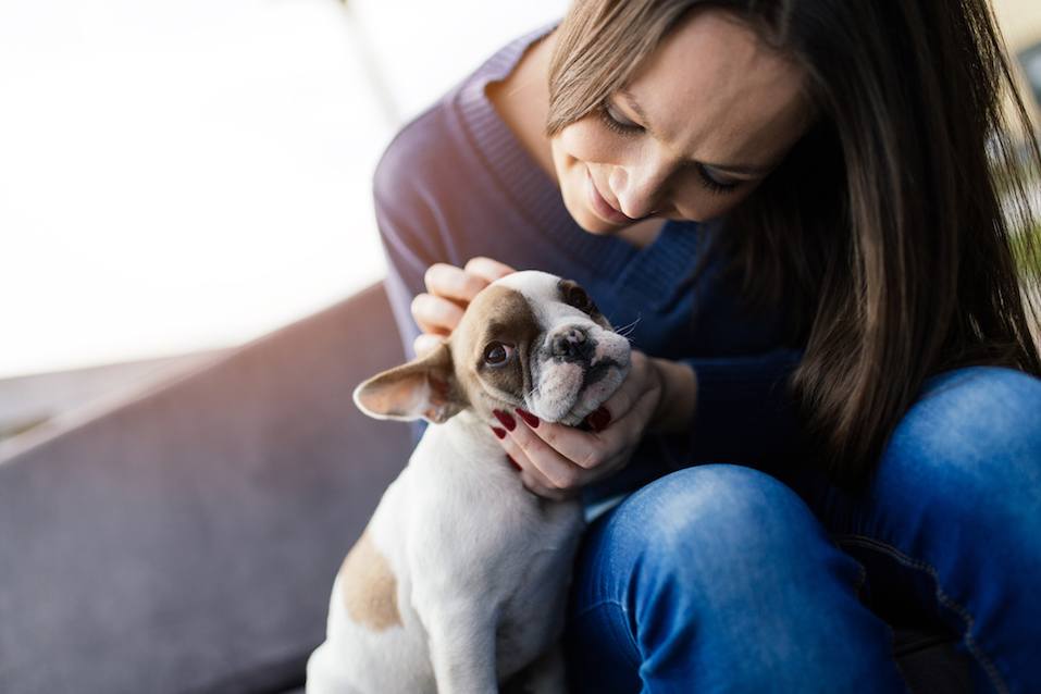 Woman and French bulldog outdoors