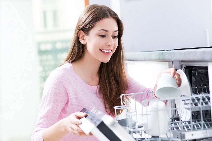 Woman loading dishwasher