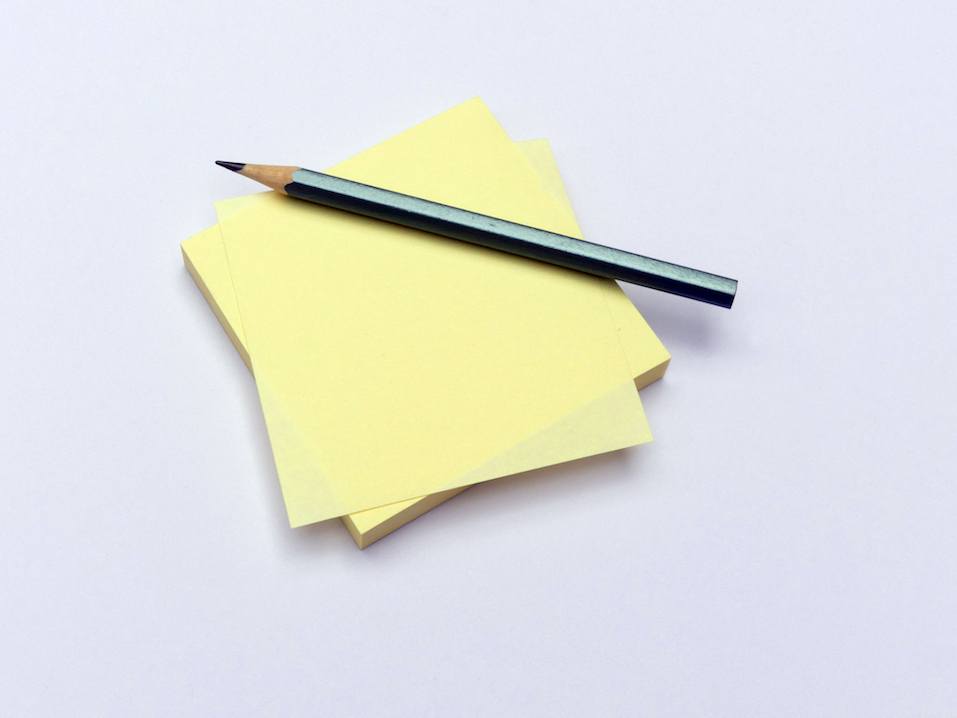 Yellow sticky notes and pencil