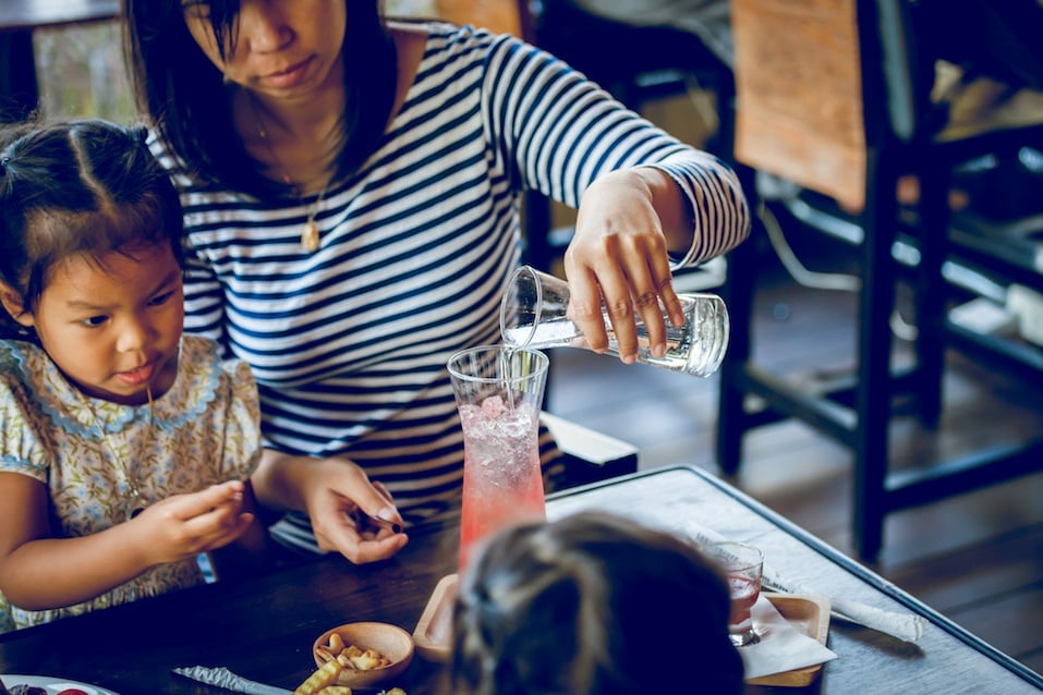 Young mother is brew drinks with daughter in cafe