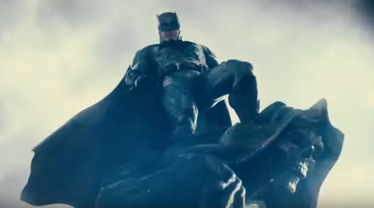 Batman towers in the sky while wearing his suit Batman towers in the sky while wearing his suit