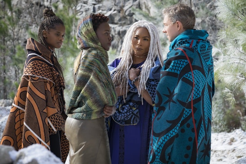 A trio of women in shawls talk with a man in Black Panther A trio of women in shawls talk with a man in Black Panther