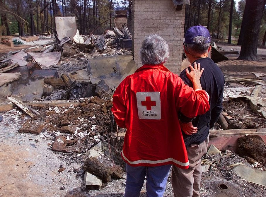 red cross volunteer comforts fire victim