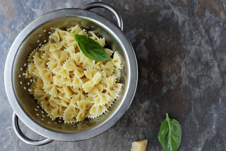 fresh bow pasta top view with basil and cheese