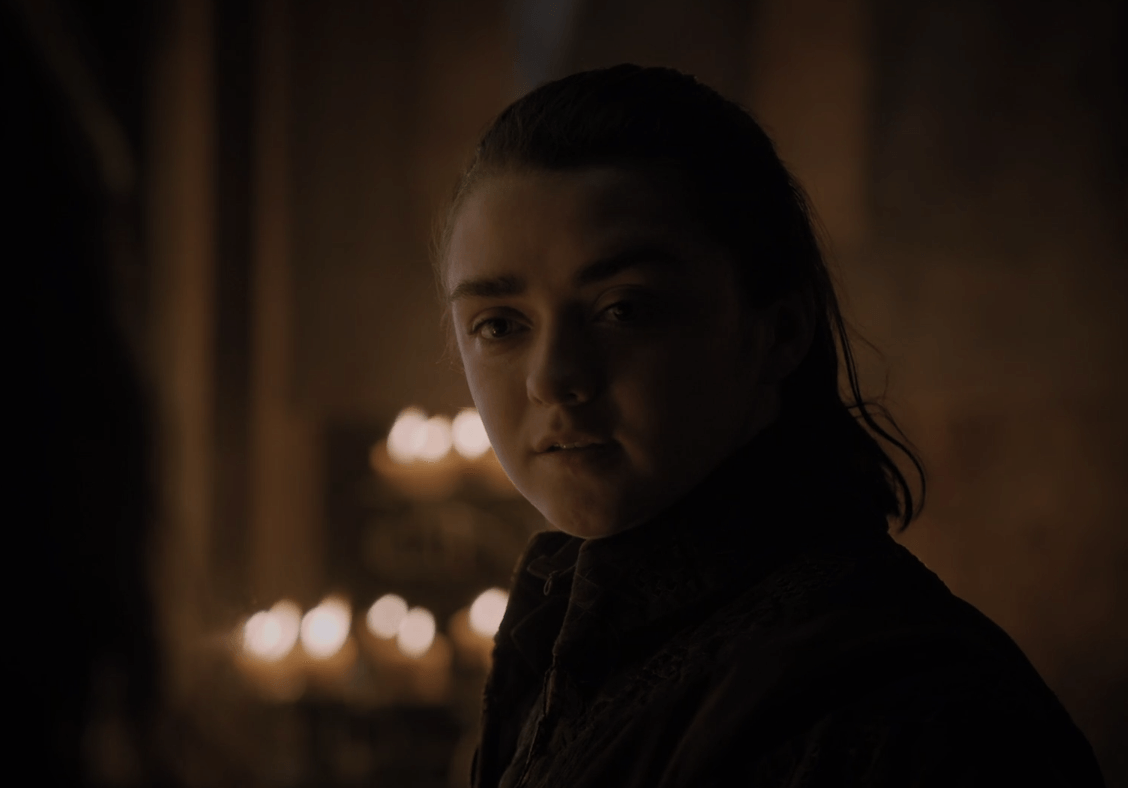 Arya Stark stands in a candlelit room in a scene from the Season 7 premiere of 'Game of Thrones.'