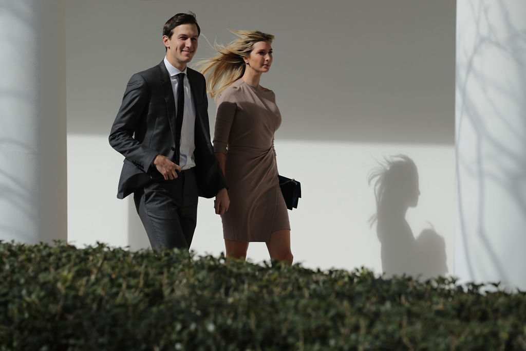 Jared Kushner and his wife, Ivanka Trump, walk down the West Wing Colonnade.