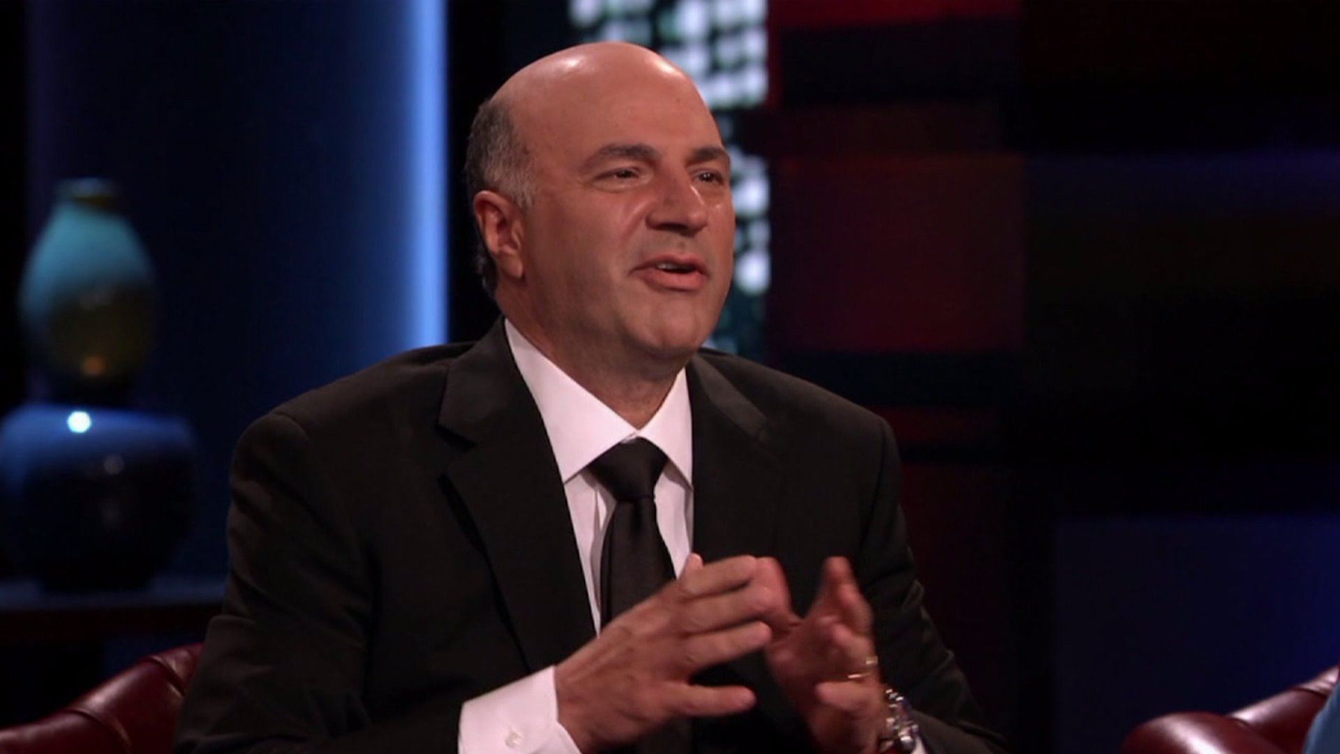 Kevin O'Leary leans forward in a chair on Shark Tank