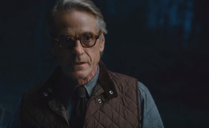 Alfred looks ahead while wearing a vest and glasses Alfred looks ahead while wearing a vest and glasses