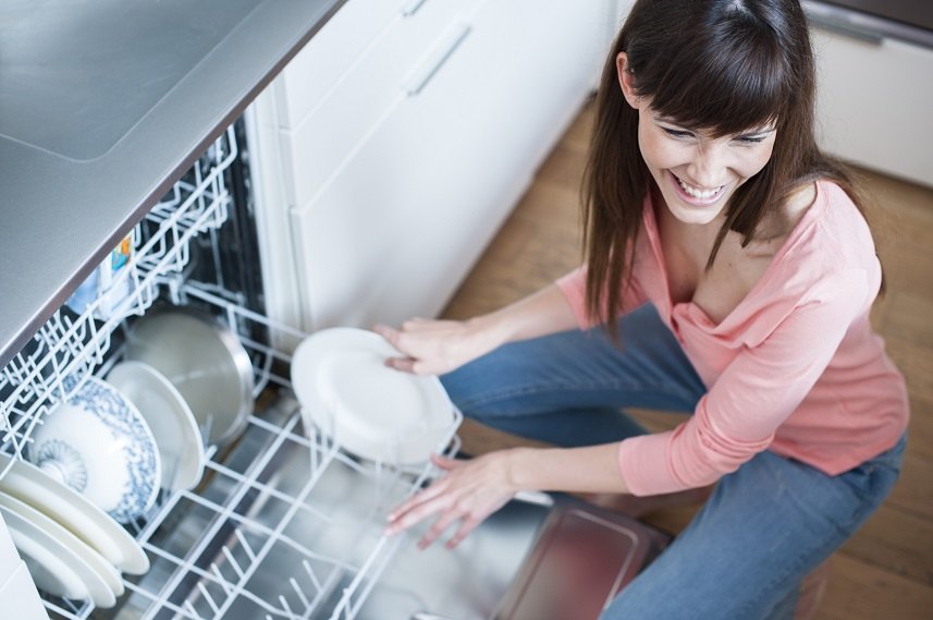 young woman in kitchen doing housework