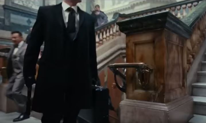 A suit-wearing man is seen from below the neck A suit-wearing man is seen from below the neck