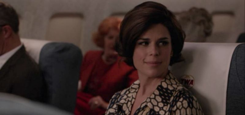 Neve Campbell sits on an airplane in Mad Men