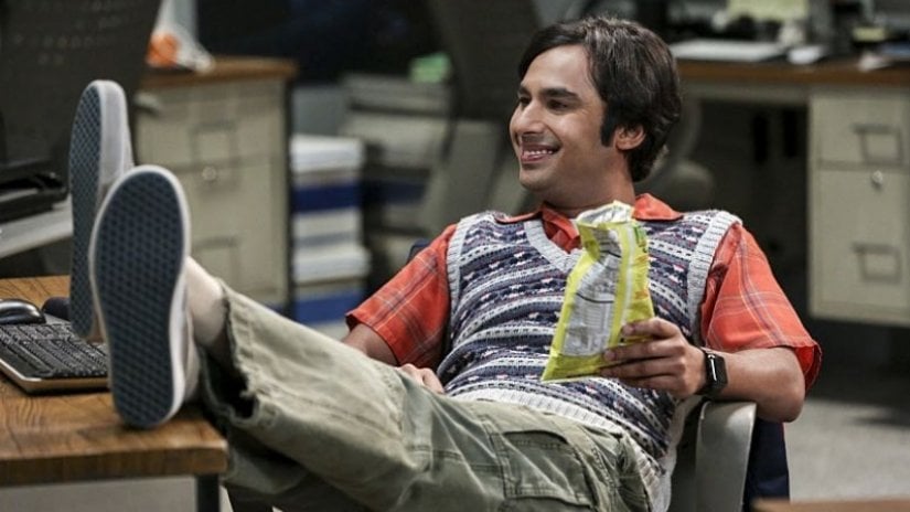 Raj leans back in his chair with his feet up on a desk in The Big Bang Theory