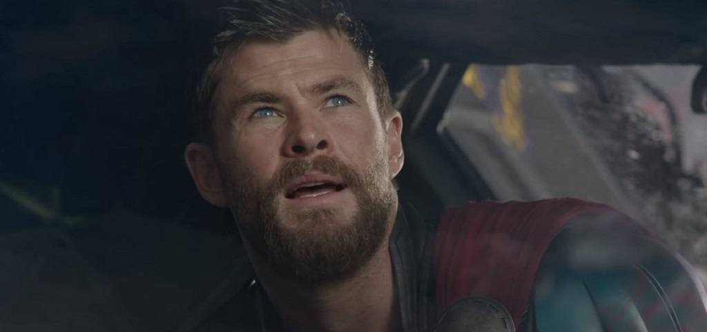 Thor opens his mouth to speak while looking up.