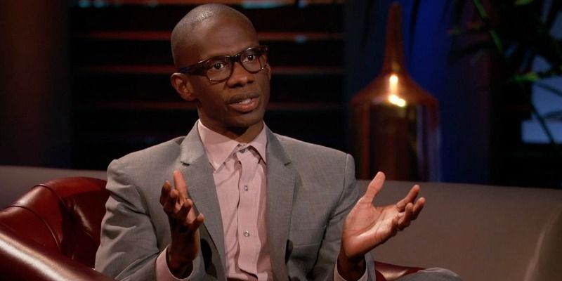 Troy Carter is talking with his hands up on Shark Tank.