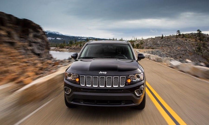 Road shot of a gray 2014 Jeep Compass from the front