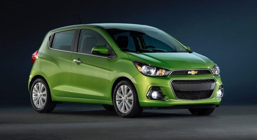 Look at a green Chevy Spark from front three-quarter view.