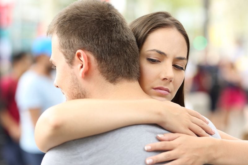 Unsatisfied woman hugging her husband Unsatisfied woman hugging her husband