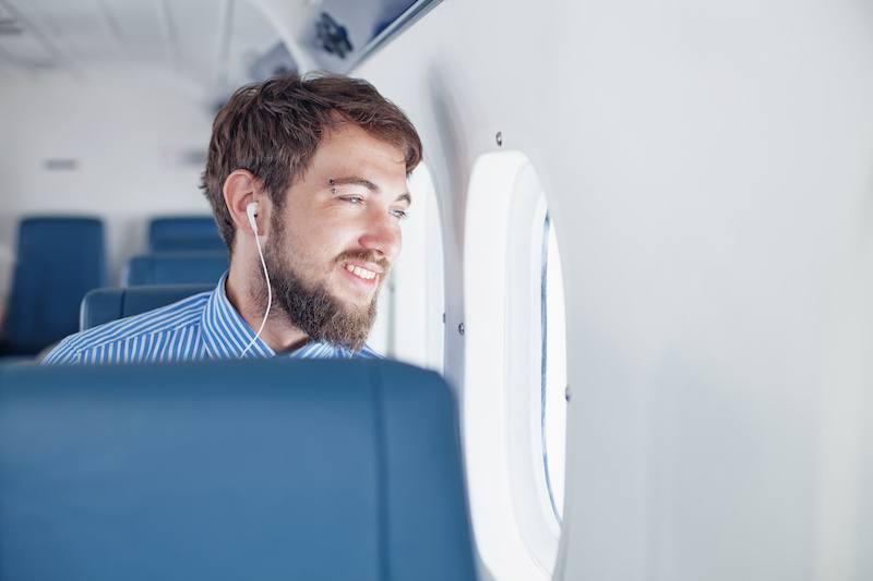 Man enjoying his journey by airplane