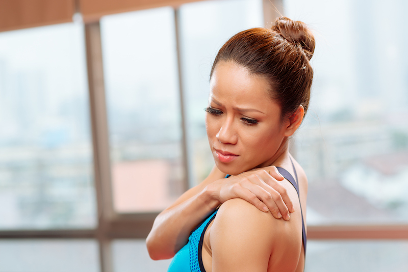woman grabbing her shoulder in pain woman grabbing her shoulder in pain