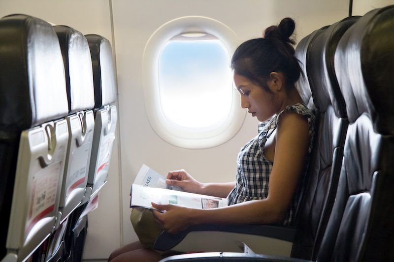 woman reading on an airplane