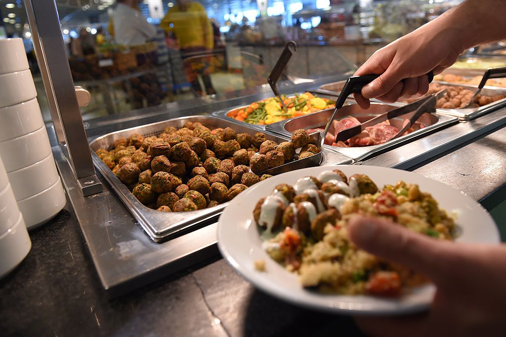 An IKEA employee serves the new IKEA vegetarian meatballs