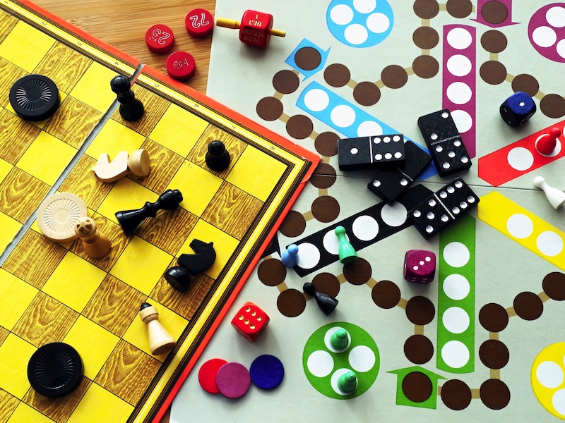 Board games set up on a wooden table.