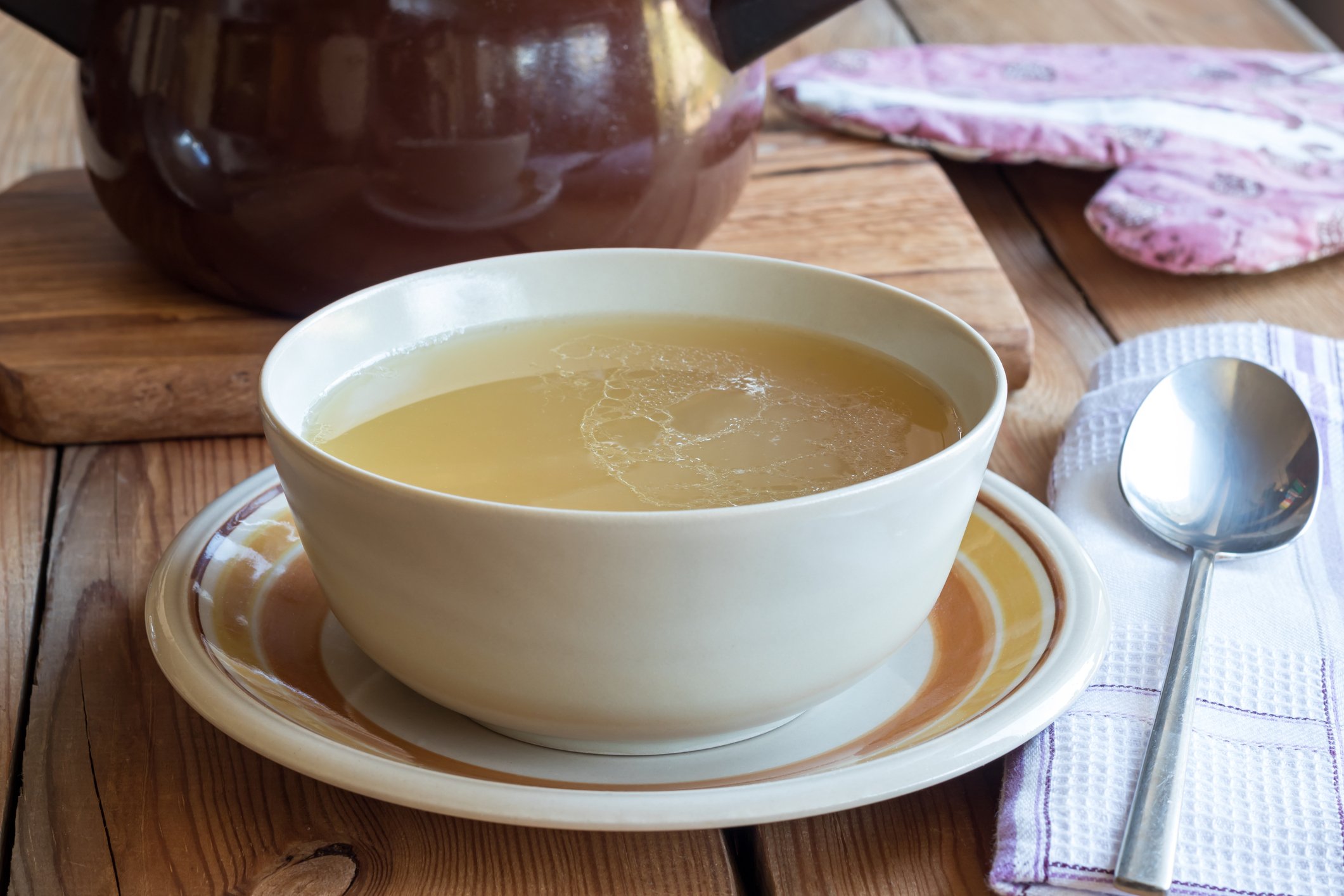 Bone broth made from chicken served in a soup bowl Bone broth made from chicken served in a soup bowl