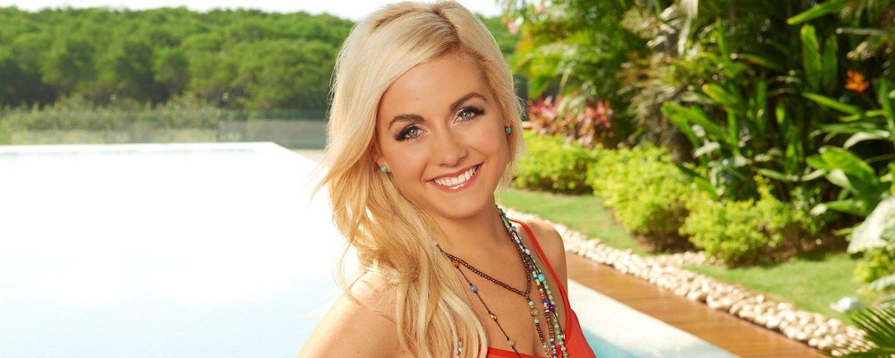 Carly Waddell stands in front of a pool