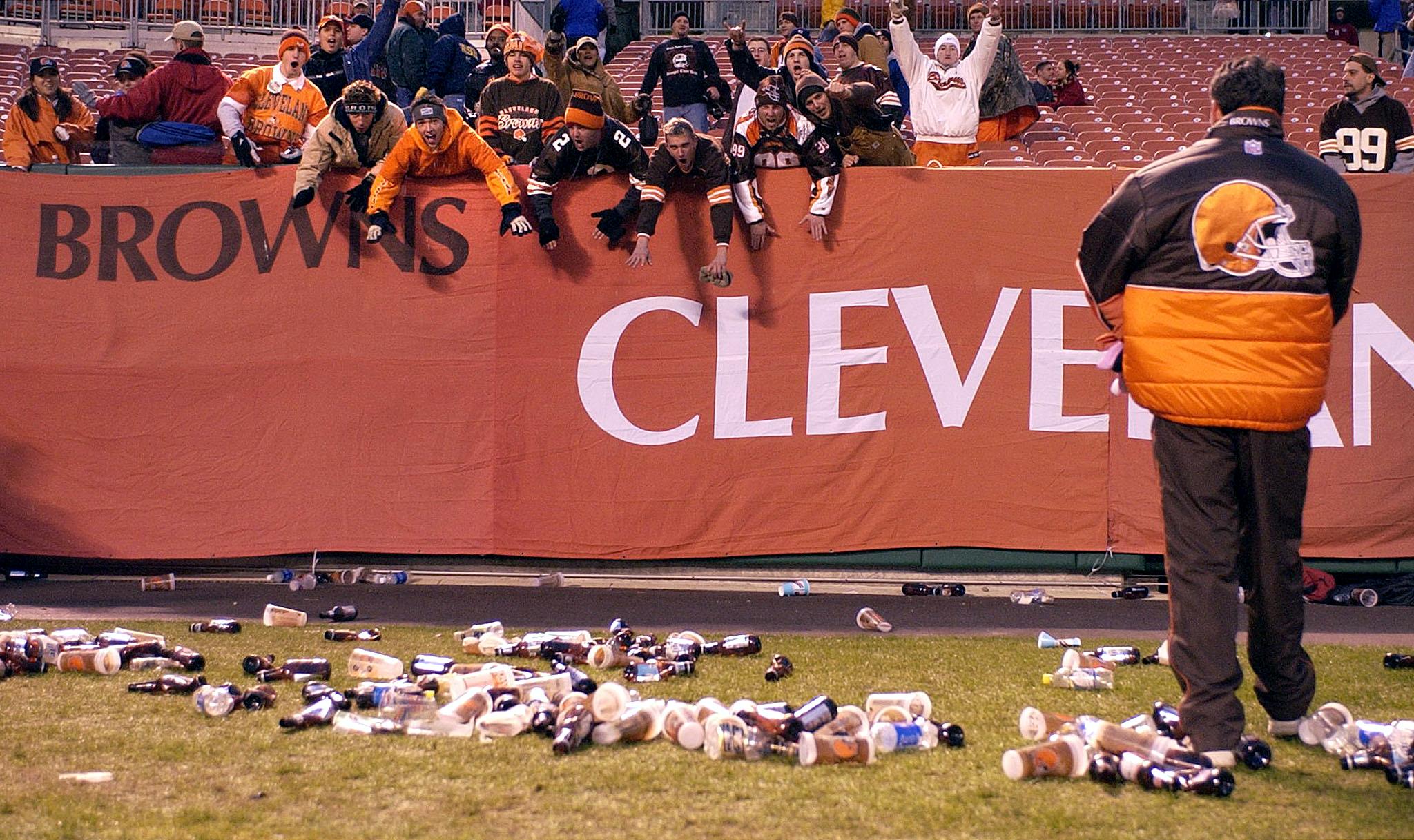 CLEVELAND, UNITED STATES: Bottles and debris litter the field at Cleveland Browns Stadium in Cleveland, Ohio, as frustrated Brown fans defy a referee's call during the Cleveland Browns-Jacksonville Jaguars NFL game 16 December, 2001. Fans began to throw beer bottles and debris onto the field after a first-down catch by the Browns was reversed and the ball given to the Jacksonville Jaguars with 48 seconds left in the game. Officials stopped the game, but later brought both teams back to play the remaining 48 seconds. Jacksonville defeated Cleveland 15-10. AFP Photo/David Maxwell (Photo credit should read DAVID MAXWELL/AFP/Getty Images)