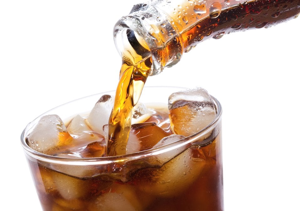 Coca Cola being poured into glass