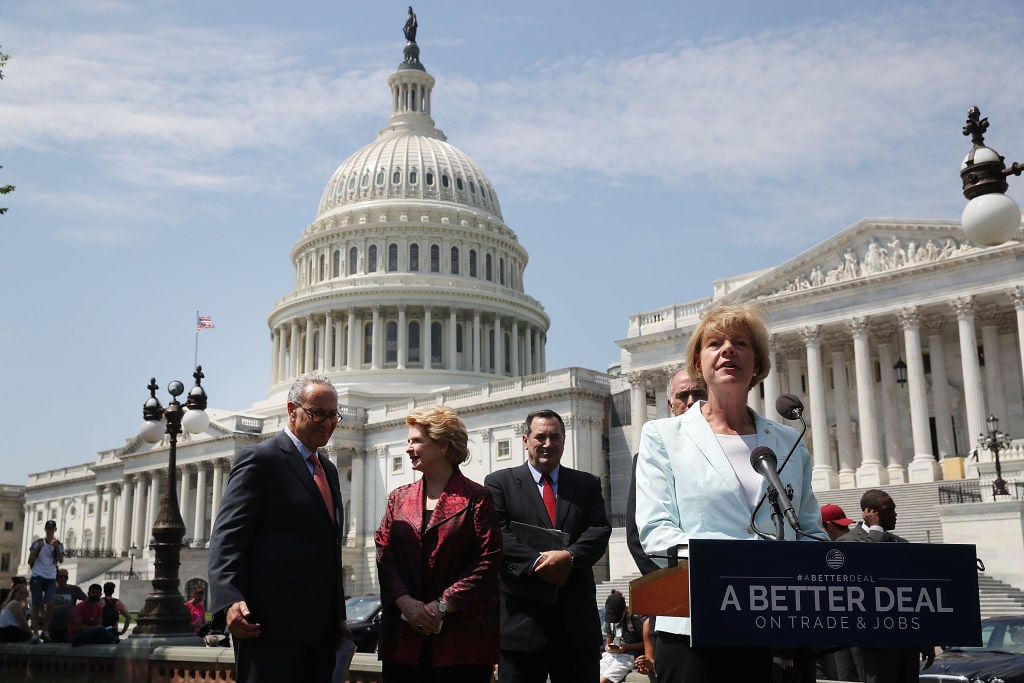 Sen. Tammy Baldwin, D-Wisconsin, speaks alongside fellow Democratic Party members, from left, Senate Minority Leader Charles Schumer, Sen. Debbie Stabenow, and Sen. Joe Donnelly during an event to unveil "A Better Deal On Trade and Jobs" in front of the U.S. Capitol. | Mark Wilson/Getty Images