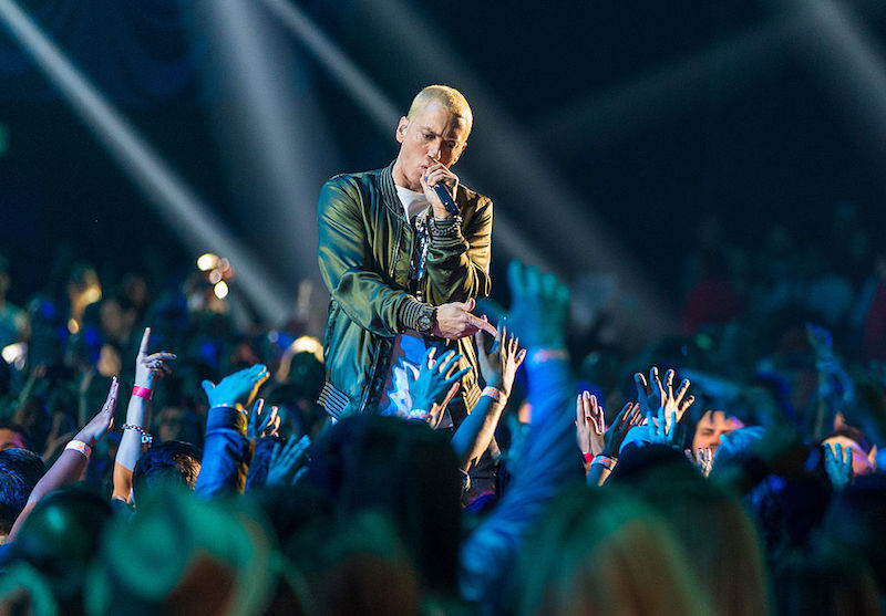 Artist Eminem performing at a concert. Artist Eminem performing at a concert.