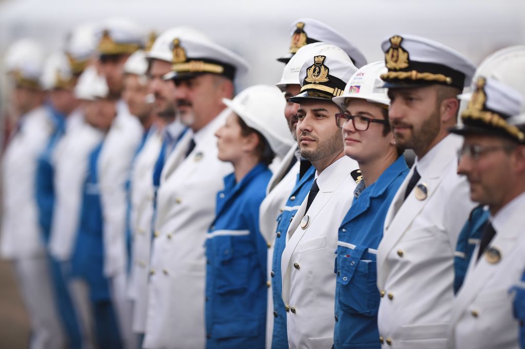 Workers and crew members gather during the delivery ceremony of the MSC Meraviglia cruise ship