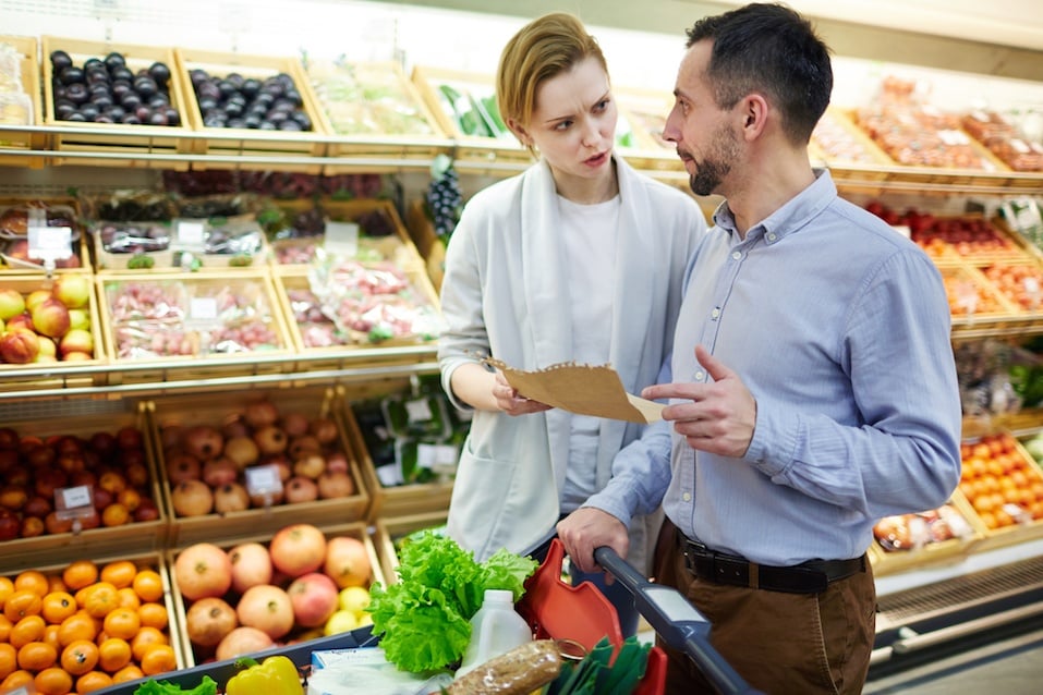 Family Discussing Shopping List in Supermarket