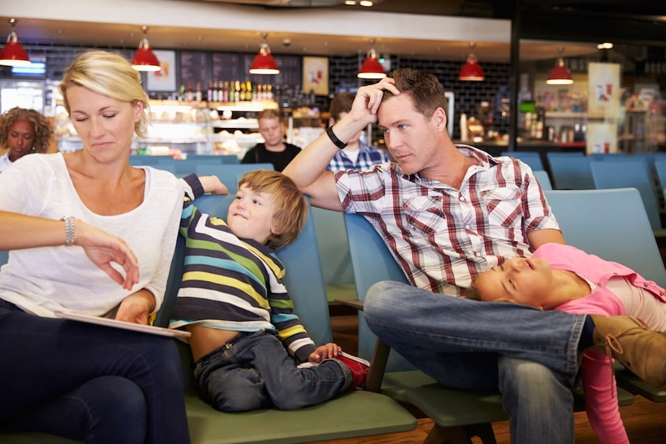 Family In Airport Departure Lounge Wait For Delayed Flight