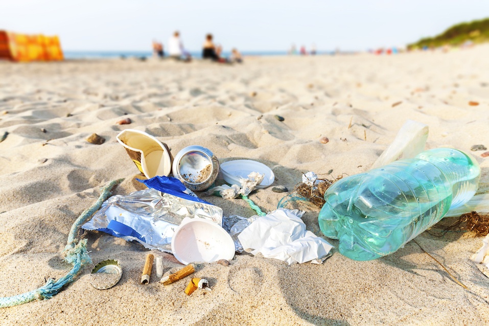 Garbage on a beach left by tourist at sunset
