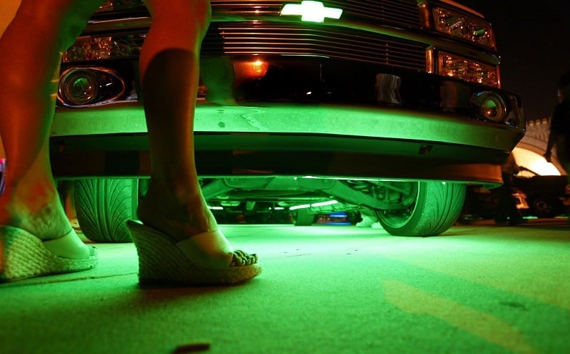 DAYTONA BEACH, FL - MARCH 27: Neon glows from under a truck during the Spring Break Nationals Glowoff Competition March 27, 2004 in Daytona Beach, Florida. A glow-off is a competition of lighting accessories such as neon lighting kits, strobe lights, LED lights and other 12-volt lighting accessories. Vehicles entered in the glow-off vie for cash prizes and best interior lighting and best exterior lighting awards. Judging is based upon creativity, cosmetic integration and installation integrity.