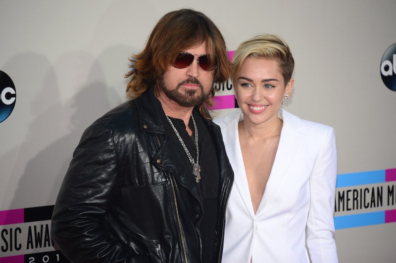 Miley Cyrus (R) and her father Billy Ray Cyrus arrive for the 2013 American Music Awards at the Nokia Theatre L.A. Miley Cyrus (R) and her father Billy Ray Cyrus arrive for the 2013 American Music Awards at the Nokia Theatre L.A.