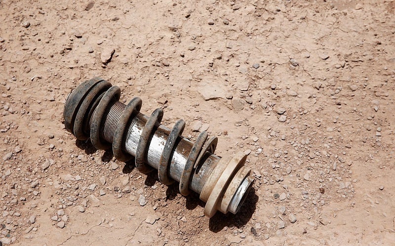 A broken coil and shock absorber spring from a race vehicle lay on the track during day 3 of the Dakar Rallly on January 6, 2015 between San Juan to Chilecito, near the town of Talacasto, Argentina.