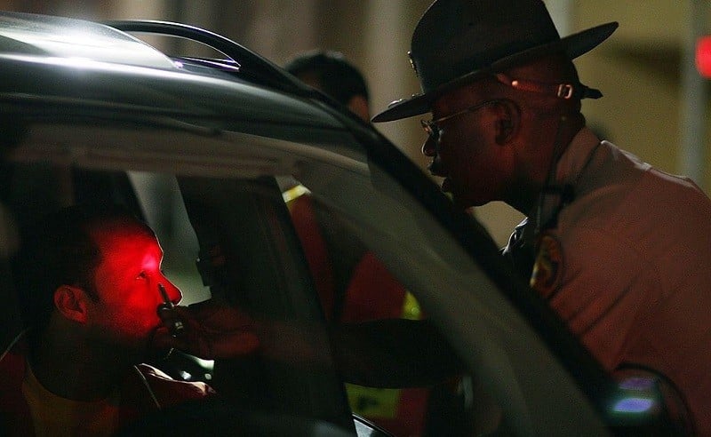 MIAMI - JULY 04: Florida Highway Patrol trooper Raymond Addison checks the eyes of a driver at a DUI traffic checkpoint June 4, 2007 in Miami, Florida. Several law enforcement agencies were conducting the checkpoint and conducting saturation patrols to help save lives during the 4th of July holiday. The National Safety Council has rated the July 4th holdiay as one of most lethal holidays for drivers, with alcohol factoring into nearly half of all motor vehicle deaths. 