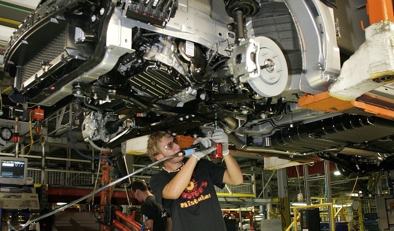 WINDSOR, CANADA - AUGUST 21: An assembly line worker installs front brake line brackets on new 2008 minivans, the Chrysler Tow & Country and the Dodge Caravan at the Windsor Assembly Plant August 21, 2007 in Windsor, Ontario, Canada.