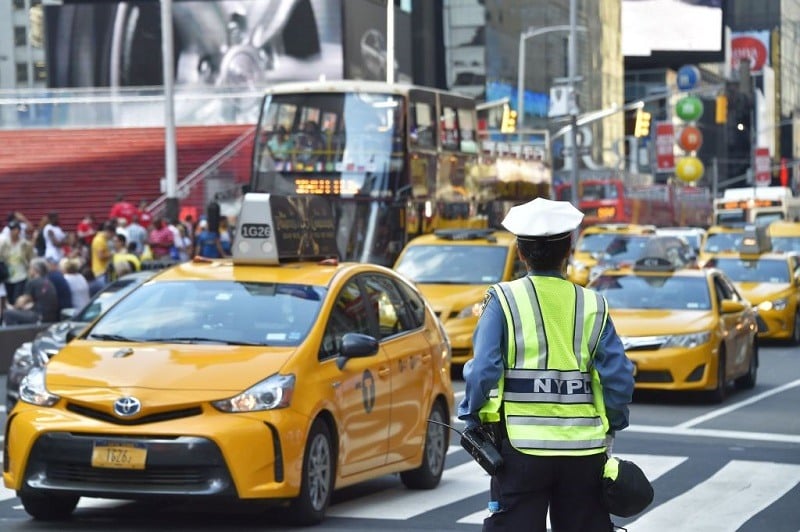 A police officer controls the traffic in Times Square, downtown Manhattan, on July 1, 2017 In New York.