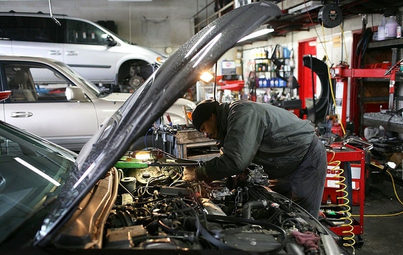 SAN RAFAEL, CA - JANUARY 05: Mechanic Antonio Ramos works on a car at San Rafael Firestone January 5, 2009 in San Rafael, California. According to a survey by the Automotive Service Association, sales at auto repair shops increased 16 percent in November as people make a small investment by way of repairs and maintenance to extend the life of their cars instead of buying a new one.