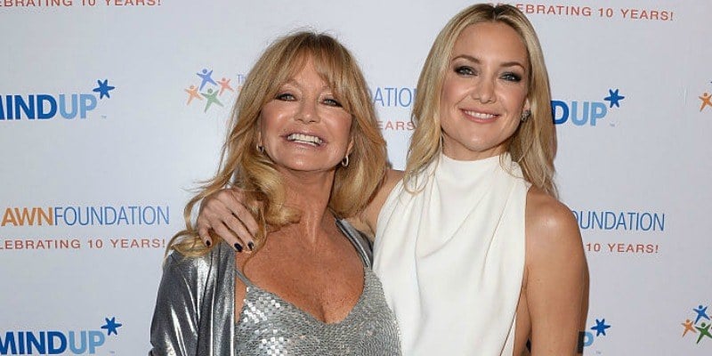 Goldie Hawn and Kate Hudson are smiling and posing together on the red carpet. Goldie Hawn and Kate Hudson are smiling and posing together on the red carpet.