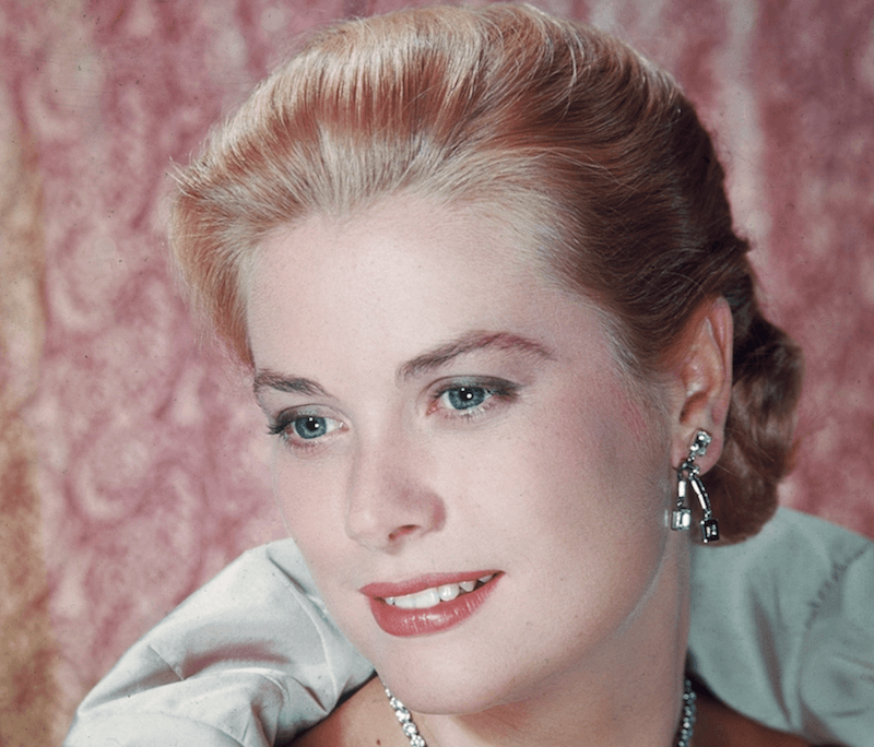 Grace Kelly poses with a gown and elaborate jewelry. 
