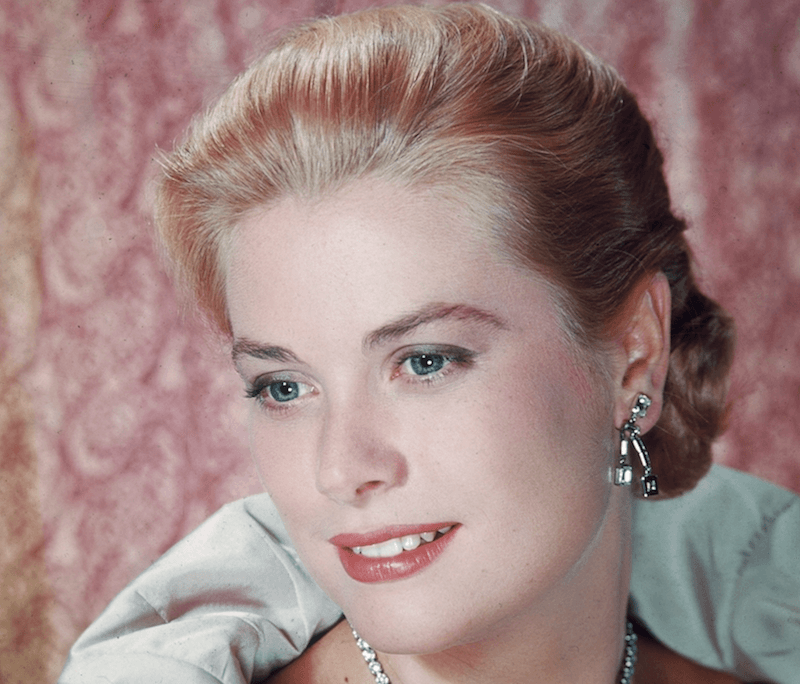 Grace Kelly poses with a gown and elaborate jewelry. Grace Kelly poses with a gown and elaborate jewelry.