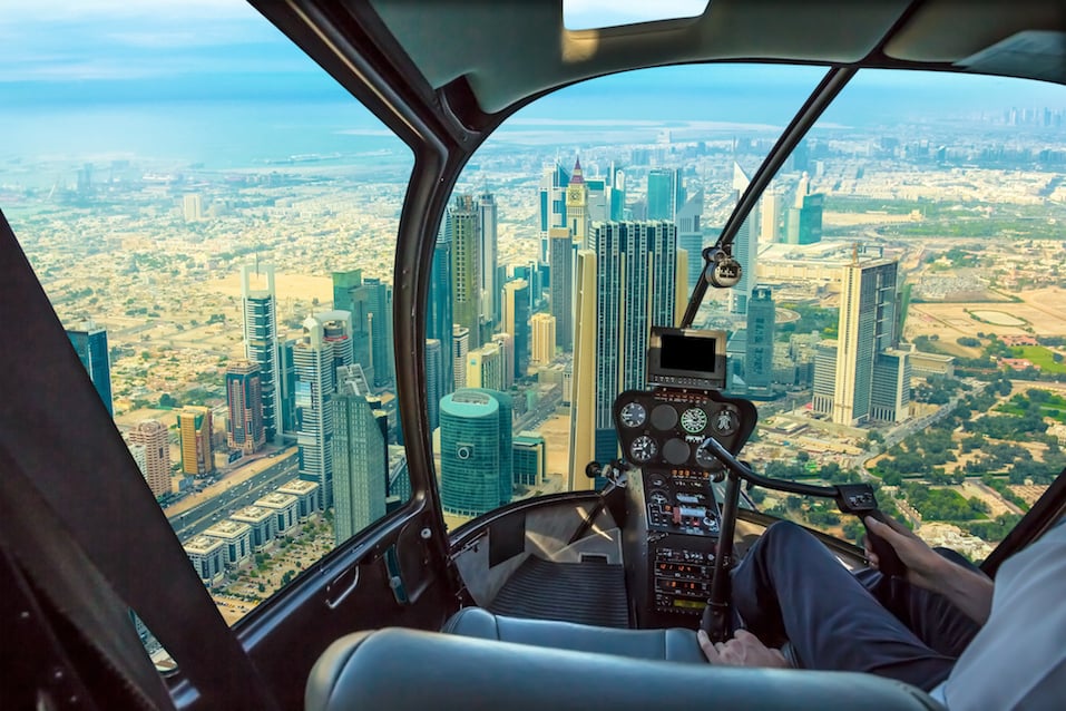 Helicopter cockpit flies in skyscrapers of Dubai downtown skyline