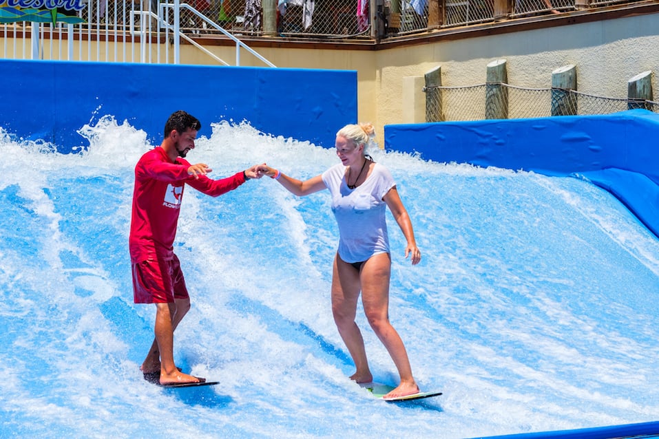 A visitor enjoying the wave riding flowrider attraction at the Margaritaville Resort